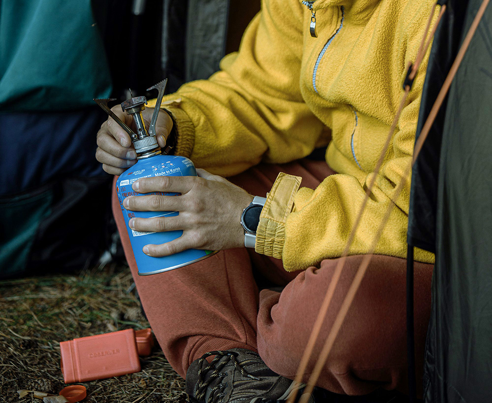 man working with camping gear